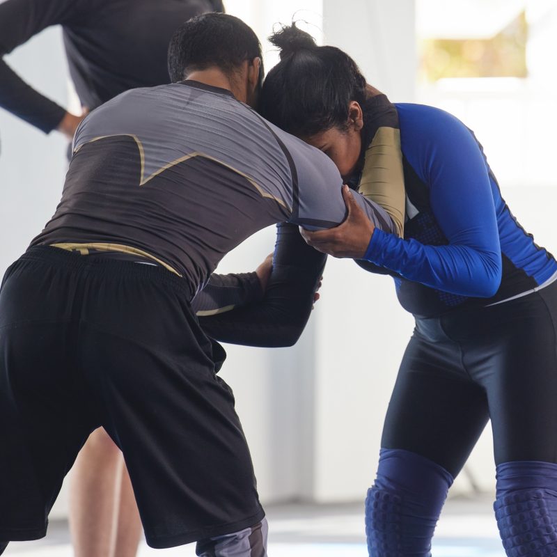 Cropped shot of a jiu jitsu sensei sparring with one of his students during a class